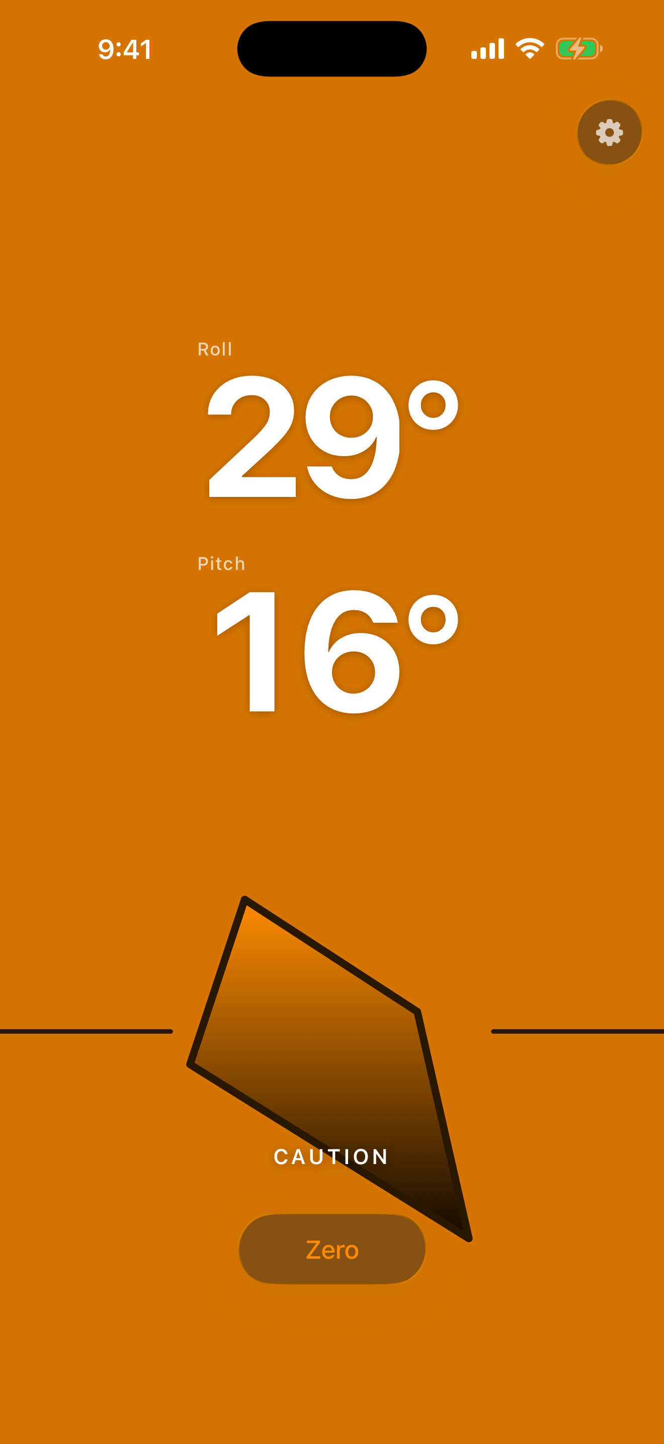 Caution state â€” the screen glowing amber as the angle climbs